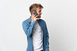 © luismolinero - Young handsome man isolated on white background keeping a conversation with the mobile phone with someone