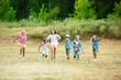 © master1305 - Kids, children running on meadow in summer's sunlight. Look happy, cheerful with sincere bright emotions. Cute caucasian boys and girls. Concept of childhood, happiness, movement, family and summer.