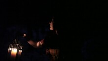 Woman In A Fancy Dress Walking In The Dark Forest In The Winter In The Night Holding A Lantern.