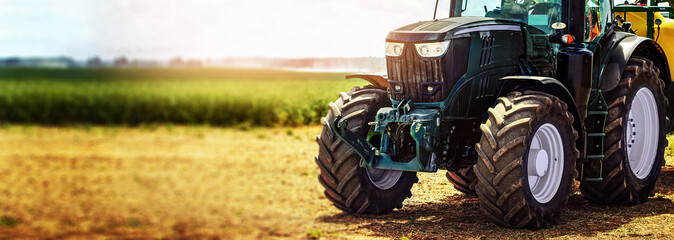 agricultural machinery farm equipment - tractor standing on the field. banner copy space