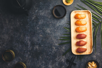 Wall Mural - Nigiri sushi set with salmon and tuna served on bamboo plate