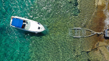 Aerial Top View Photo Of Inflatable Speed Boat On Trailer Being Towed By Truck From Emerald Exotic Sea To Land