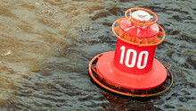 The Red Buoy With The Number 100 Bobs On The Waves