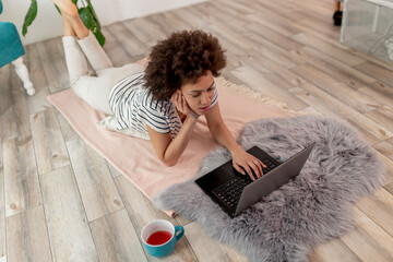 Wall Mural - Female freelancer working remotely from home