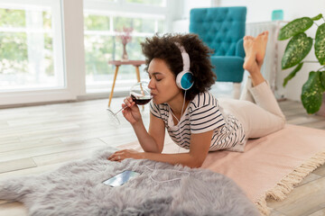 Wall Mural - Woman listening to the music and relaxing at home