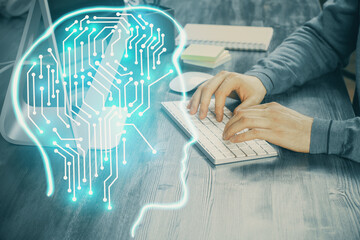 Man typing on keyboard background with brain hologram. Concept of big Data. Double exposure.