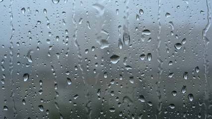 Wall Mural - Heavy rain. Raindrops roll down the window pane during a windy thunderstorm.