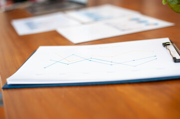 Documents to analyze business overview on the desk.