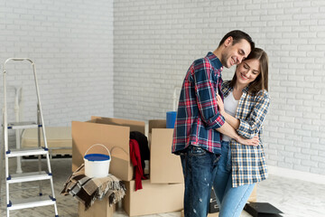 Happy young couple moving together in new apartment