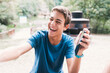 © nacho roca - Teenage boy having fun with someone using smartphone