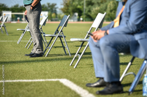 Photographie Chairs on the turf of a soccer field maintaining the social distance imposed by