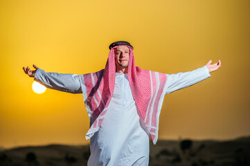 Wall Mural - Portrait of Arabic man on a middle of yellow desert.