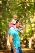© Sk Elena - The child sits on his fathers shoulders. Father and baby walking in the park. Summer time. Happy family spent time together outdoors.