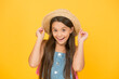 © be free - Good vibes. Portrait of happy cheerful girl in summer hat yellow background. Beach style for kids. Little beauty in straw hat. Fancy vacation outfit. Teen girl summer fashion. Summer holidays
