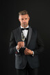 © be free - Handsome man tuxedo suit drink champagne black background, celebrate anniversary concept