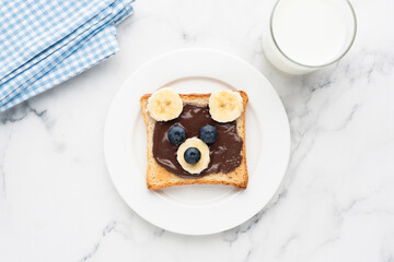 Teddy bear toast with chocolate spread, banana and blueberry. Kids food, children's breakfast or lunch menu