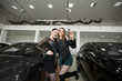 © Artem Zakharov - Two female friends are happy to buy a car at a car dealership