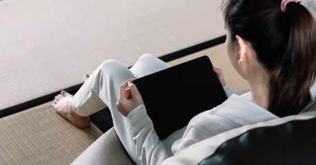 Above view of woman using smart tablet at home