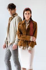 Wall Mural - young, stylish couple looking at camera while posing isolated on white