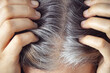 A woman showing her gray hair roots