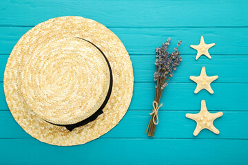 Canvas Print - Summer straw hat with starfishes and lavender flowers on blue wooden background