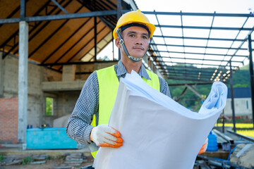 Poster - Engineer working with blueprint on building site.