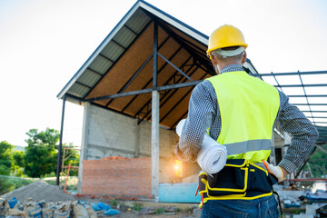 Poster - Engineer working with blueprint on building site.