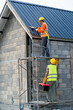 © visoot - Construction worker wearing safety harness are install new roof,Concept of residential building under construction.