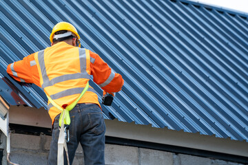 Poster - Roofer working on roof structure of building on construction site.