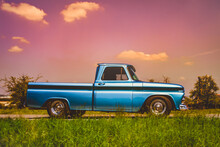 Side View Of An Old Classic Car On The Street. Retro Style Photo Of An American Oldtimer Pick-up From The 1960's. Vintage USA Truck At Sunset. Oldschool Travel, Traffic Concept