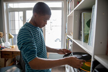 Teen Boy Playing Music Record In Home Office