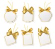© YummyBuum - Tags with gold bows. Blank white price paper labels with golden ribbons for christmas, birthday or wedding packaging gift vector realistic isolated templates collection
