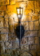 An old torch burns on a stone wall in an castle
