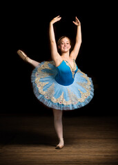 Beautiful smiling ballerina girl dancing