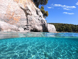 Fototapeta Paryż - Underwater and sea level photo of amazing tropical rocky turquoise clear seascape with caves and natural pine trees