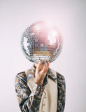 1970s Disco man in a leisure suit with a glittering disco mirror ball for a head