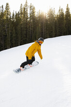 Man Snowboarding On Snowy Ski Slope