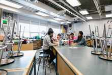 High School Students Talking And Studying In Science Laboratory Classroom