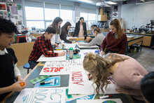 High School Teacher And Students Preparing For Environmental Rally