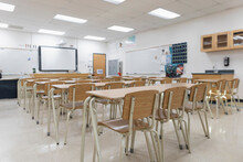 Desks In A Row In Empty High School Classroom