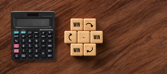 Wall Mural - cubes with message WIN -> WIN -> WIN and a calculator on wooden background