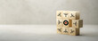 cubes with bow and arrow symbols all pointing into the middle to an target symbol on paper surface in front of concrete background