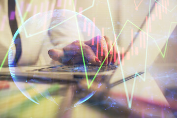  Double exposure of businesswoman hands typing on computer and financial graph hologram drawing. Stock market analysis concept.