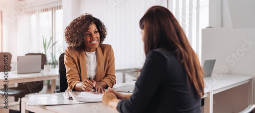 Photographie Woman consulting with a female financial manager at the bank