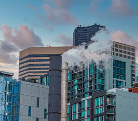 Fototapete - Steam from Smokestack in front of modern buildings in Seattle