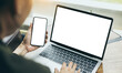 © panitan - computer,cell phone mockup image.hand woman work using laptop texting mobile.blank screen with white background for advertising,contact business search information on desk in cafe.marketing,design