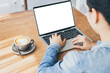 © panitan - computer mockup image blank screen.hand woman work using laptop with white background for advertising,contact business search information on desk at coffee shop.marketing and creative design