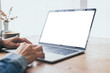 © panitan - computer mockup image blank screen.hand woman work using laptop with white background for advertising,contact business search information on desk at coffee shop.marketing and creative design