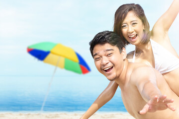 Asian man holding his girlfriend in a bikini