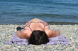 low angle of a pregnant woman sunbathing on the beach